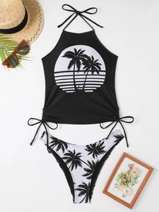 Flat lay of black and white tropical palm print bikini with summer beach accessories