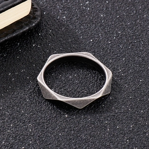 Macro view showing geometric diamond-cut edges on a vintage silver titanium steel ring