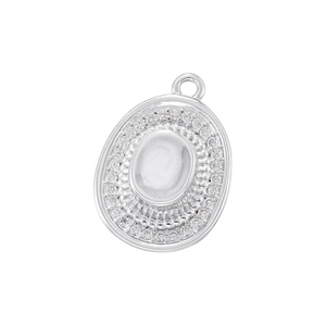 Macro detail of oval silver pendant with embedded crystals and metallic ring holder