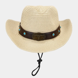 Detail of western straw cowboy hat featuring vintage bull head buckle and turquoise accents