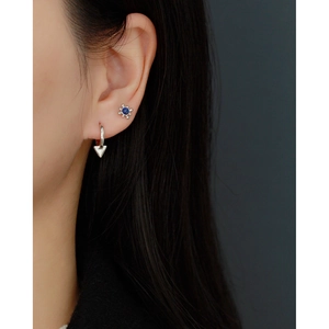 Close-up of S925 sterling silver earring with blue lapis lazuli and triangle charm