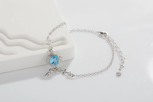 S925 sterling silver bracelet with blue heart-shaped gemstone and key pendant detail