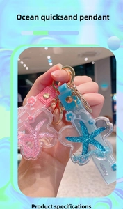 Close-up of ocean-themed acrylic liquid keychains with pink and blue starfish sequins