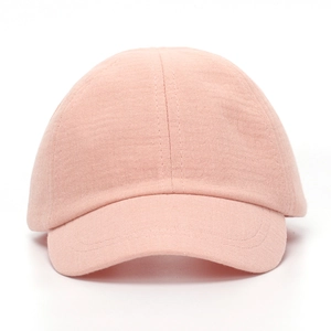 Close-up of soft pink knitted cotton baby hat with cute bow and textured breathable fabric
