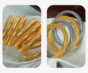 Macro detail of 10mm retro striped elastic snake bone bracelet in gold and silver finish