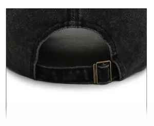 Detail of adjustable vintage washed black cotton baseball cap with bronze metal buckle