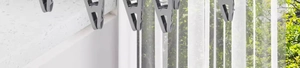 Detail of durable grey laundry clips on a hanging rack with outdoor background