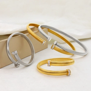 Sparkling crystal nail head spring bangles in gold and silver finish set in display box