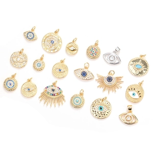 Assorted gold and silver evil eye pendants with sparkling blue and white zircon stones