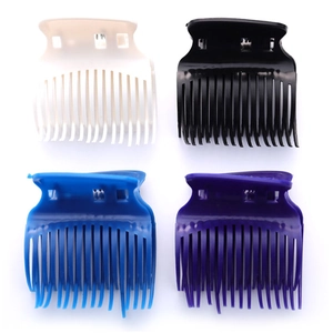 Set of four colorful salon hair clips in white, black, blue, and purple with fine teeth