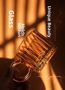 Close-up of amber glass mug featuring vertical striped texture and large circular handle
