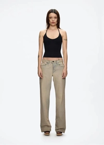 Front view of black halter top paired with tan washed jeans on a model