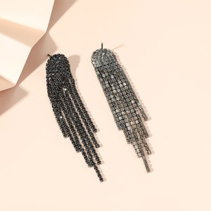Macro shot of long black rhinestone fringe earrings with six rows of dangling crystals