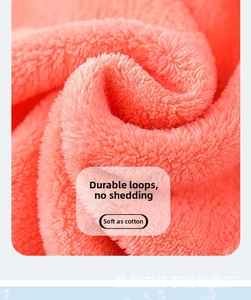 Detailed macro view of soft coral fleece towel with dense loops and plush pink texture