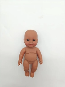 Detailed top view of a lifelike African reborn baby doll with brown skin and smiling face