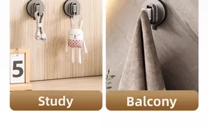 Deep grey suction cup hook holding a heavy dry towel on a textured stone wall