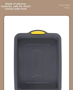 Macro detail of deep gray silicone brownie mold featuring a yellow grip handle