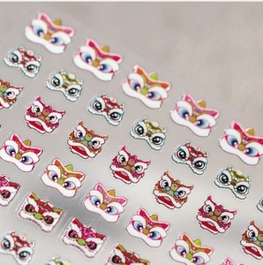 Close-up of 3D Chinese lion dance nail art stickers with glitter finish and textures