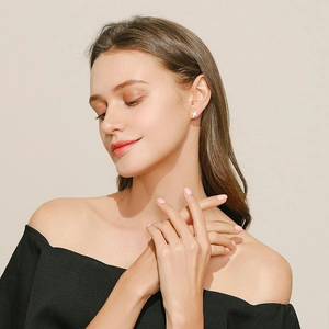 Elegant S925 silver heart stud earrings with opal stone shown on a female model
