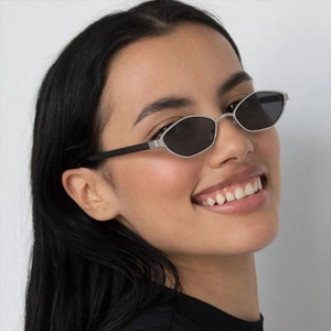 Modern polygon metal sunglasses with silver geometric frames and black temples on a model