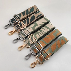 Close-up of adjustable woven shoulder straps with leaf patterns and metal buckles
