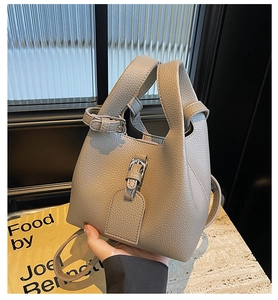 Close-up of elephant gray lychee texture bucket bag with a vertical buckle detail