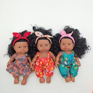 Detailed trio of realistic black baby dolls in colorful paisley and floral outfits