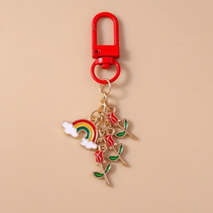 Detailed view of rainbow cloud and red enamel roses on a luxury metal keychain