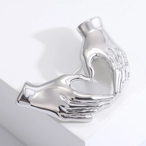 Minimalist silver heart hands gesture brooch with polished mirror finish for coats