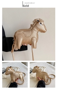 Detailed view of the gold horse-shaped crossbody bag with lychee texture and tassels