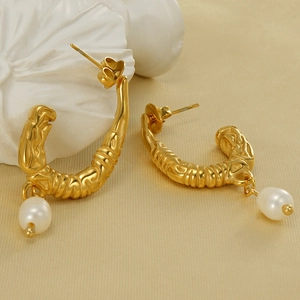 U-shaped gold stainless steel earrings with molten texture and white pearl pendant