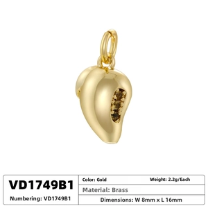 Macro detail of 2.2g gold brass pendant set with three dark gemstones, 8mm by 16mm size