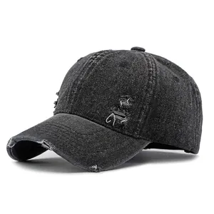 Distressed black denim baseball cap with vintage frayed holes and retro street style