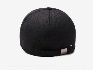 Detail of black winter baseball cap with corduroy texture and adjustable metal buckle back