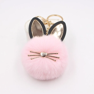 Pink fluffy cat fur ball keychain with gold cat ears and whiskers for bags and car keys