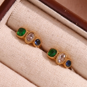 18K gold plated earring with green, white, and blue gemstones in a beige jewelry box
