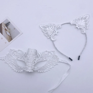 Detail of white lace cat ear headband and masquerade mask with satin ribbons