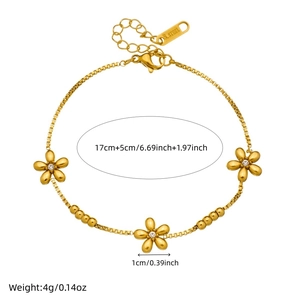 Gold-plated stainless steel floral bracelet with crystal centers and size measurements