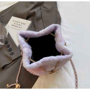 Top view of purple faux fur bucket bag showing drawstring closure and gold chain strap