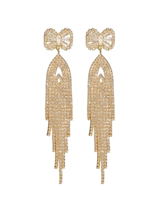 Close-up of gold bow earrings with long sparkling tassel zirconia chains