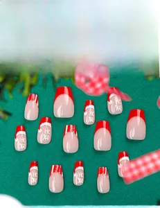 Macro detail of Christmas press-on nails featuring red stripes and Ho Ho festive designs