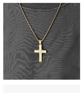 Detail of hip hop two-tone cross pendant with tire texture design on a mannequin