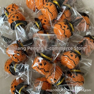 Batch of packaged Halloween crochet pumpkins with black wizard hats for bulk festive gifts