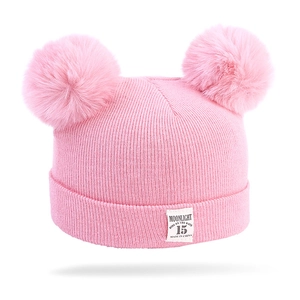 Pink knit baby beanie with two large faux fur pom-poms and ribbed cuff design