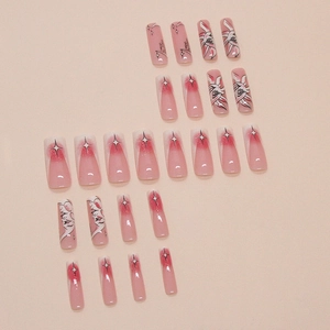 Pink gradient coffin press on nails featuring black starburst and face art designs