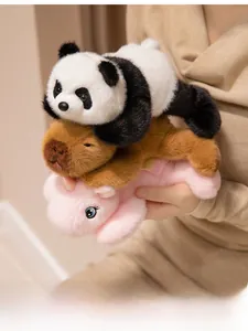 Close-up of soft plush panda, capybara, and pink mascot toys held by a model