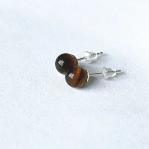 Macro view of 6mm tiger eye stone stud earrings with S925 silver and silicone backs
