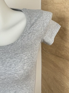 Detailed close-up of grey marl texture and stitching on the slim fit U-neck T-shirt