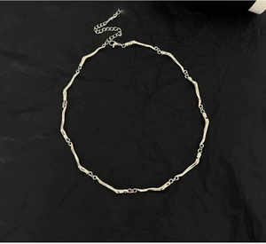 Detail view of silver irregular wave link chain with lobster clasp and extension