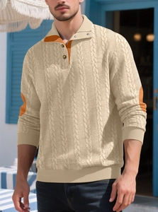 Close-up of beige knit sweater with orange elbow patches and half-buttoned collar